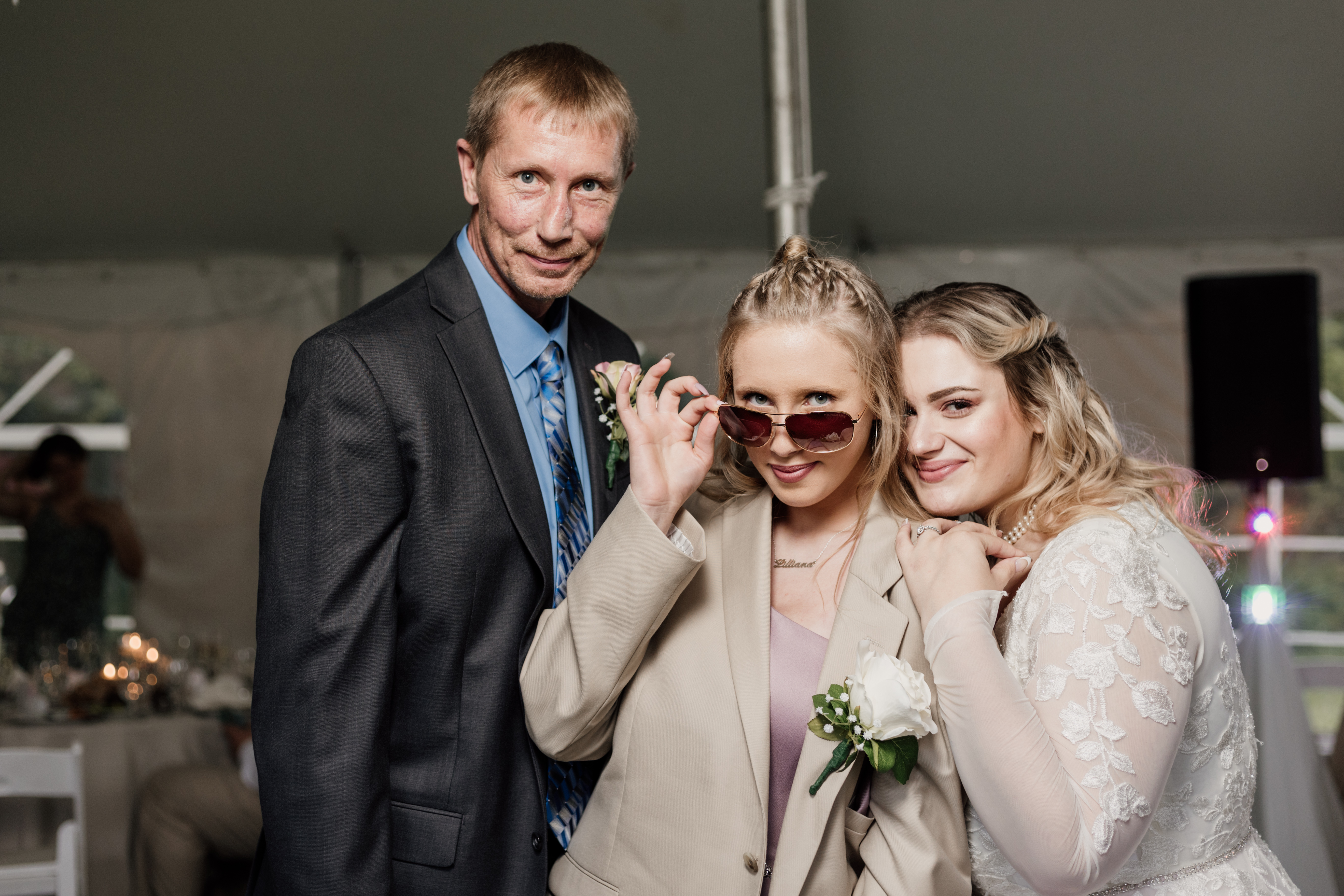 Fun family photograph at the reception of a spring wedding in Historic Odessa Delaware wedding venue, including the bride, sister of the groom with sunglasses indoors, and the father of the groom.