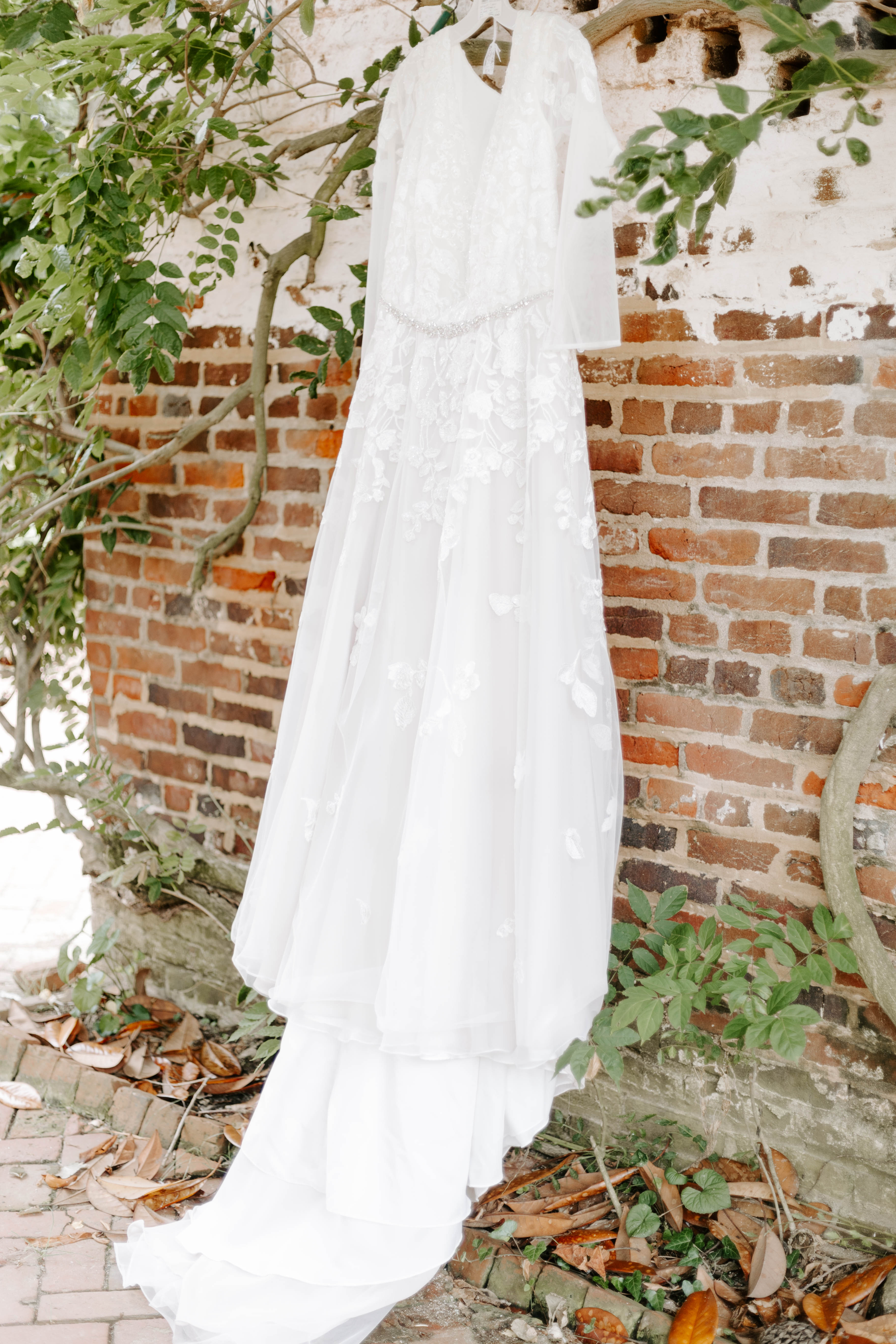 Spring wedding dress hanging for Delaware wedding  at Historic Odessa. Modern wedding photographer and Delaware wedding photographer Alli McGrath photographed this candid moment.