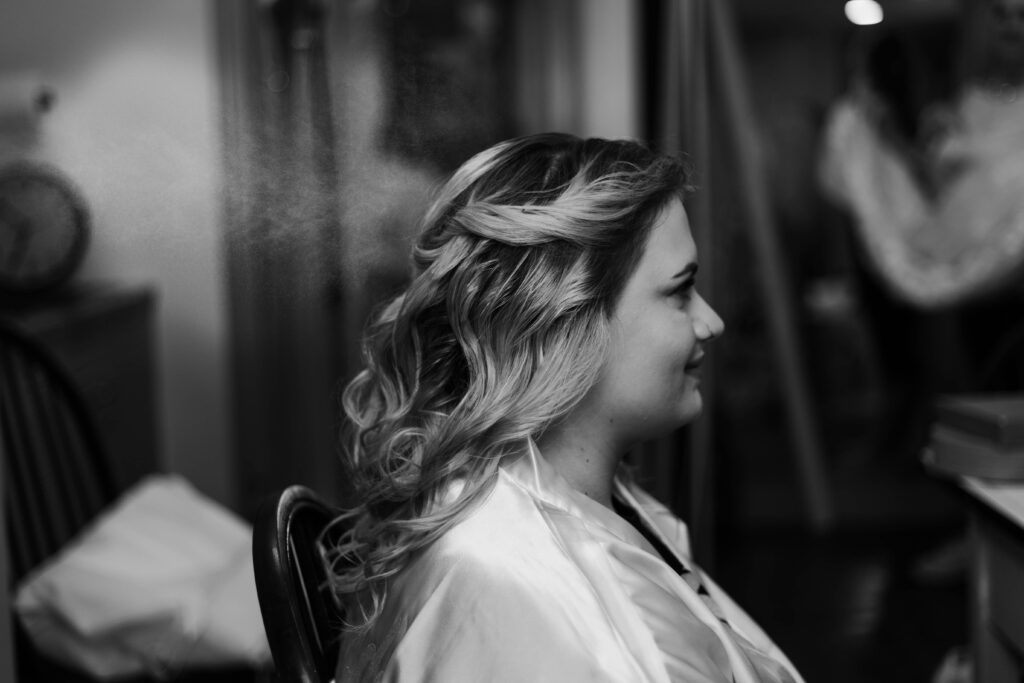 Getting ready photo of bride during a spring wedding in Delaware at Historic Odessa. Modern wedding photographer and Delaware wedding photographer Alli McGrath photographed this candid moment.