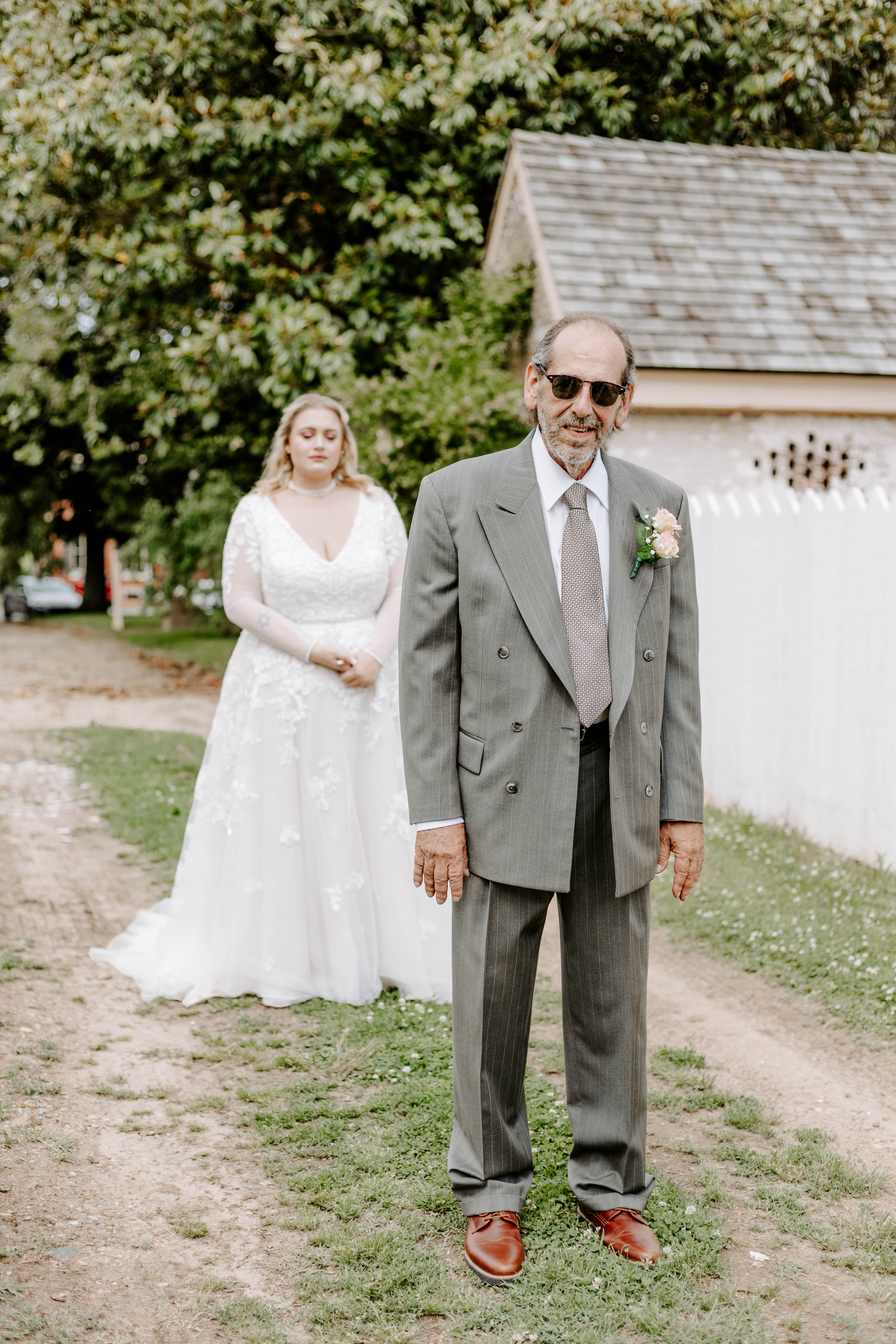 Bride standing behind father before father daughter first look at spring wedding in Delaware at Historic Odessa Delaware wedding venue. This moment was photographed by Delaware wedding photographer and modern wedding photographer Alli McGrath Photography.