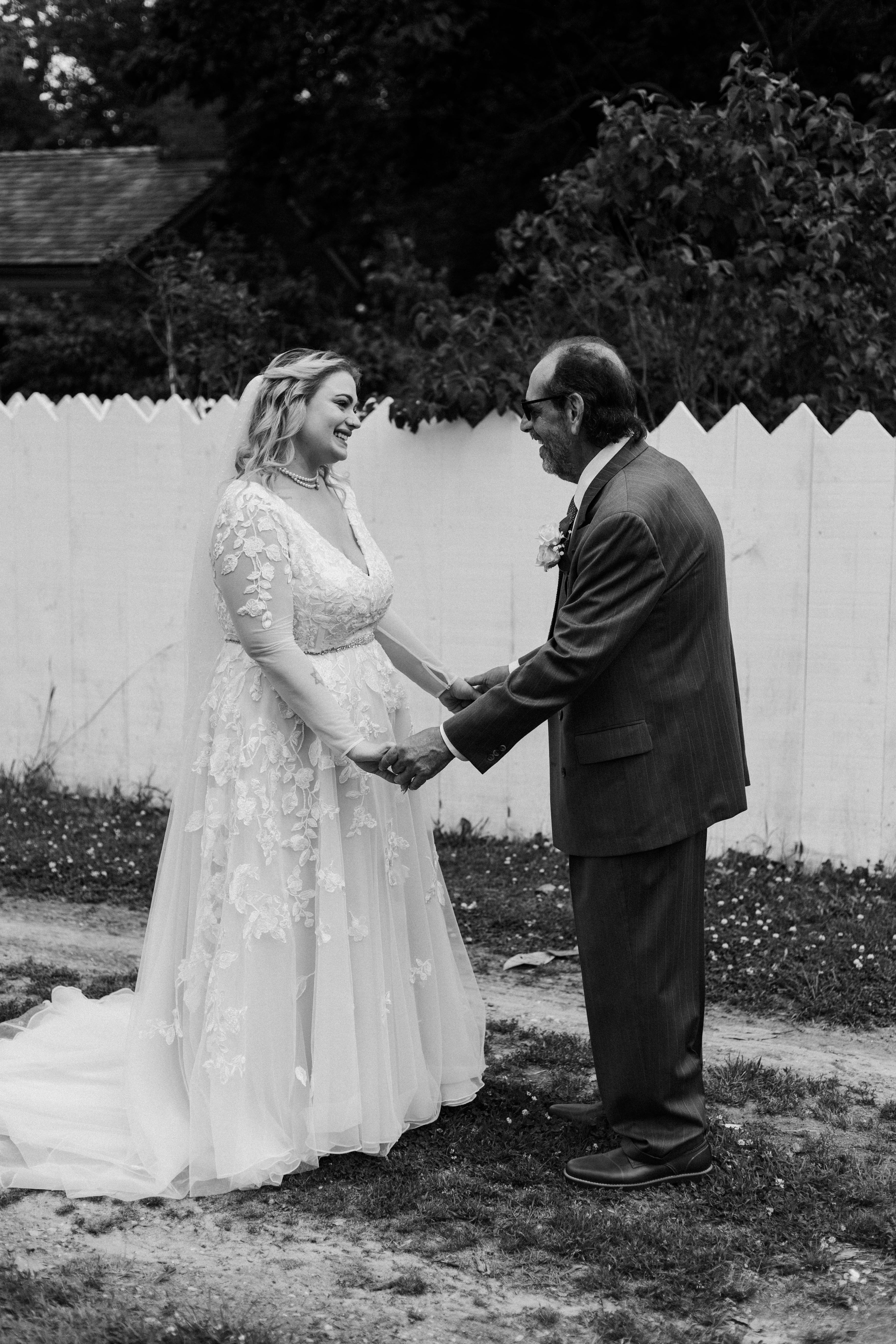 The bride and her father are holding hands after the father daughter first look at spring wedding in Historic Odessa Delaware